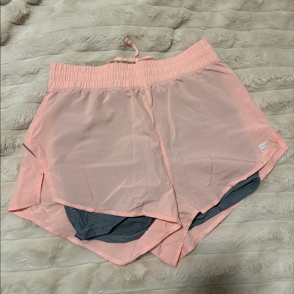 Layered Fabletics pink shorts